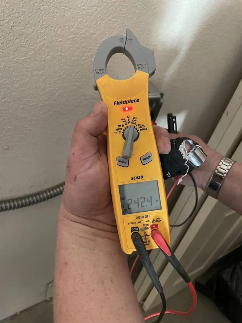 Voltage testing with clamp meter during Whole House Surge Protector in Geneva